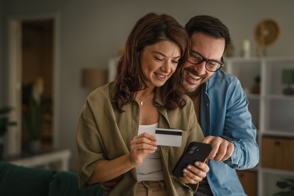Happy couple holding keys to their new home