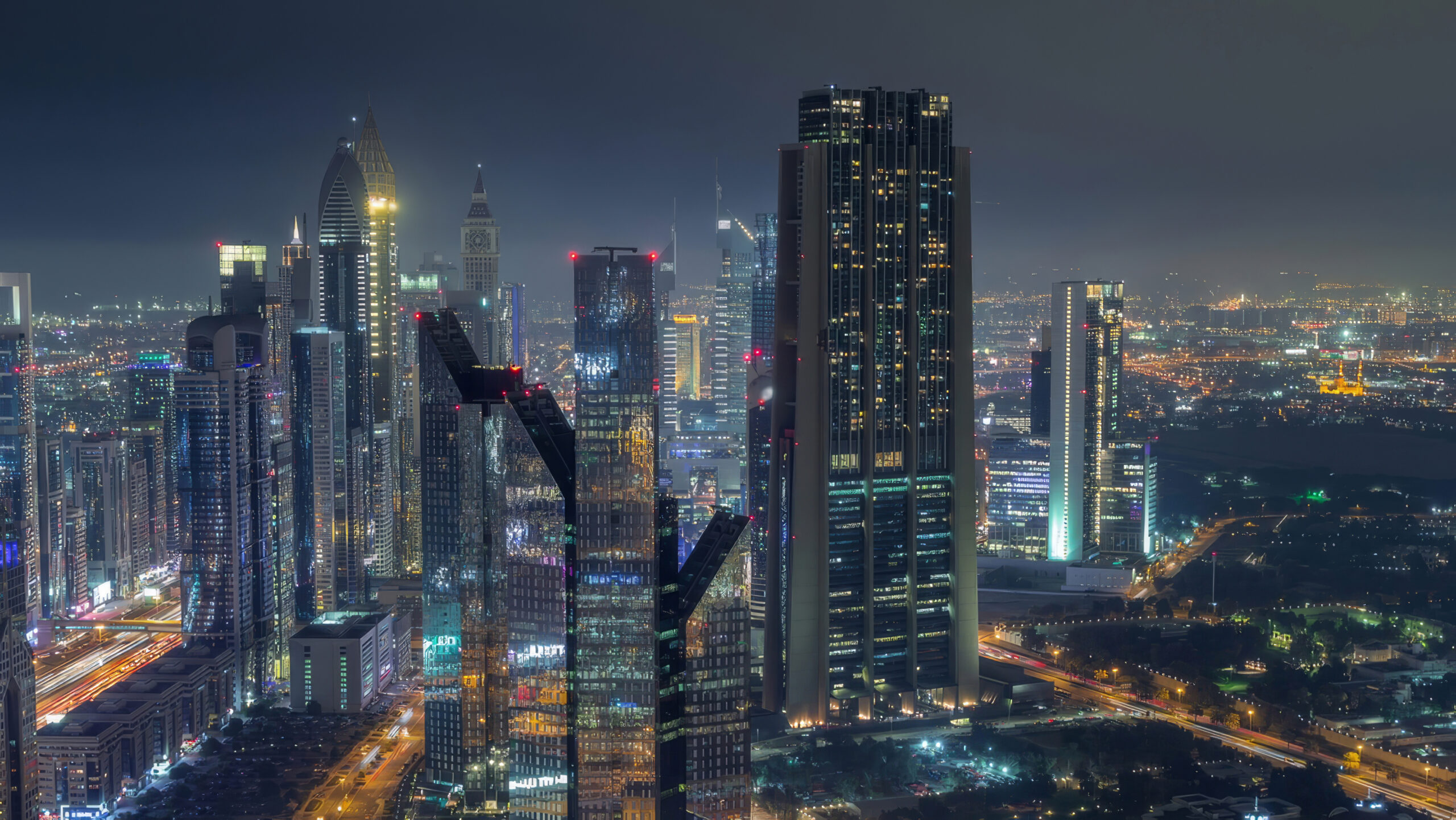 Towers along Sheikh Zayed Road, Dubai, lit at night.